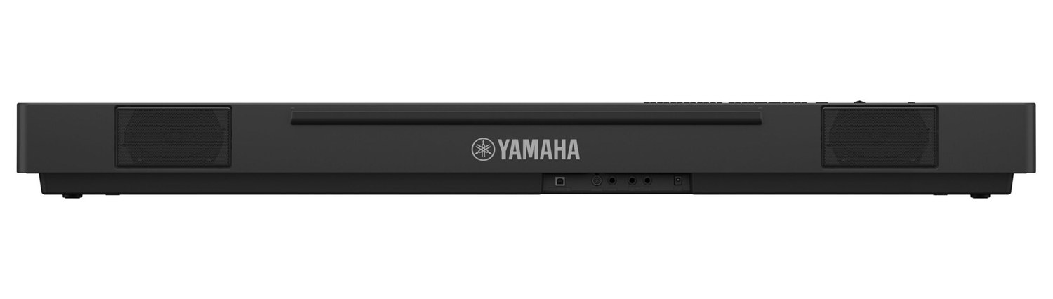 Задняя панель портативного пианино Yamaha P-225: две прямоугольные решётки динамиков по краям и ряд разъёмов посередине